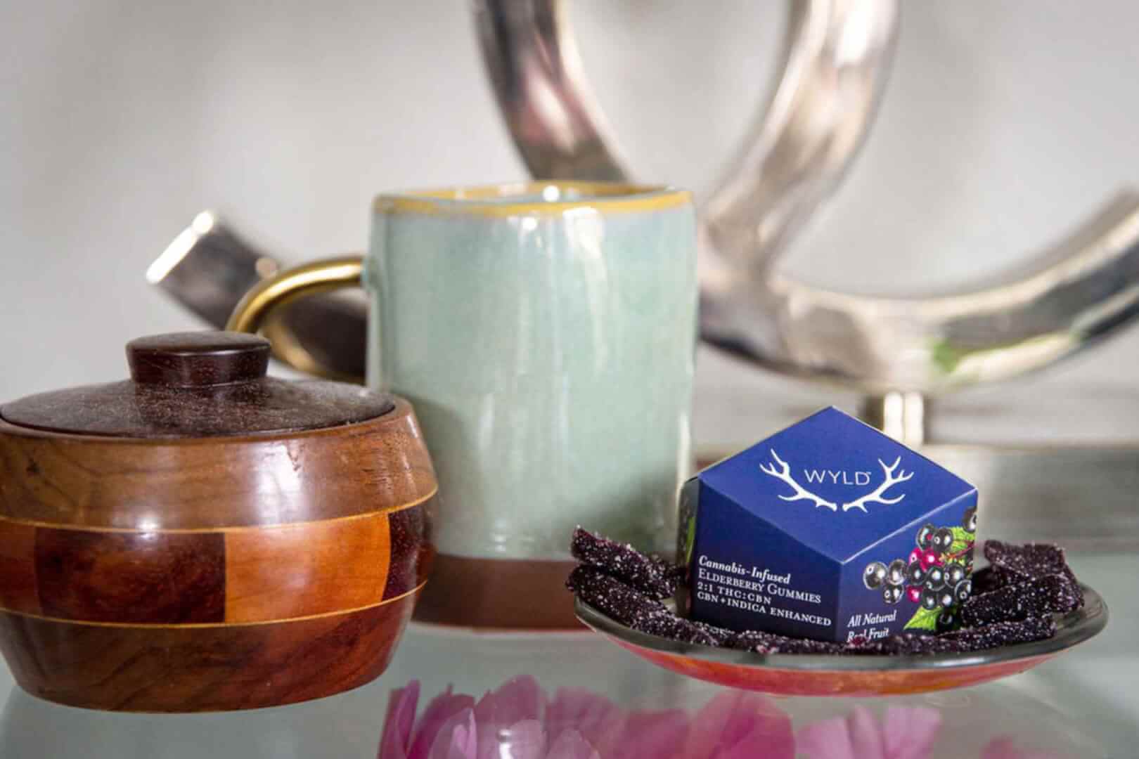 A pack of CBN Elderberry Wyld Gummies on a person's nightstand for an easy night's sleep.